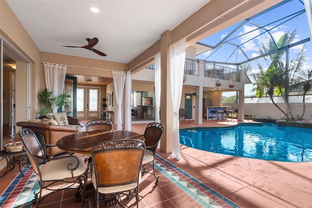 view of swimming pool featuring french doors and ceiling fan