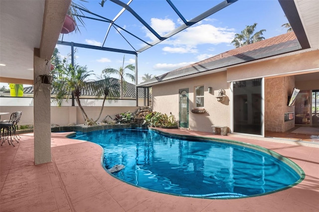 view of swimming pool with glass enclosure and a patio