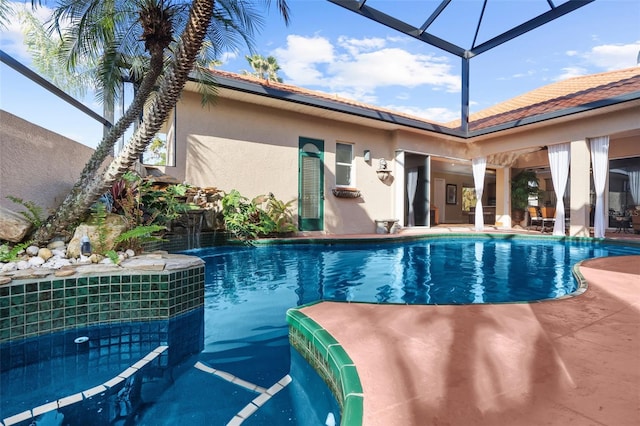 view of pool featuring glass enclosure and a patio area