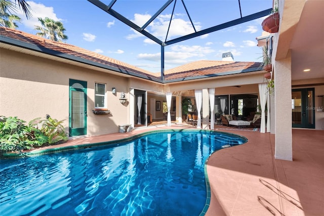 view of swimming pool featuring a patio and a lanai