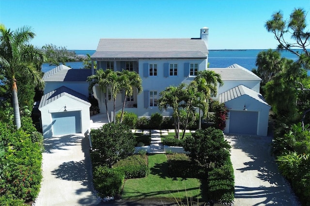 view of front facade featuring a water view and a garage