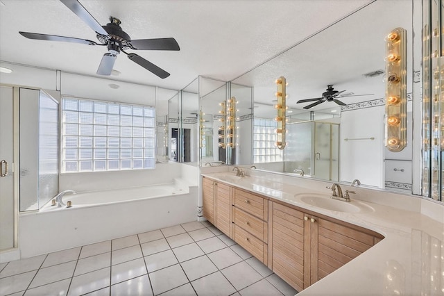 bathroom featuring vanity, tile patterned flooring, ceiling fan, separate shower and tub, and a textured ceiling