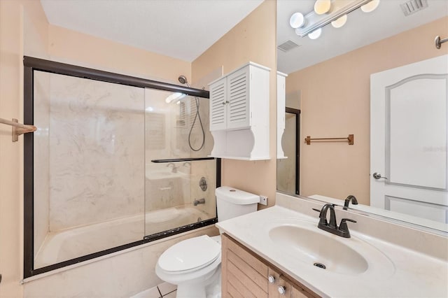 full bathroom with combined bath / shower with glass door, vanity, toilet, and tile patterned flooring