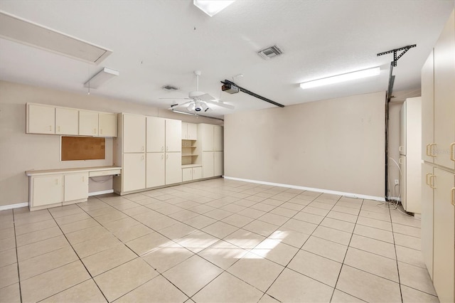 unfurnished room with ceiling fan, light tile patterned floors, and a textured ceiling