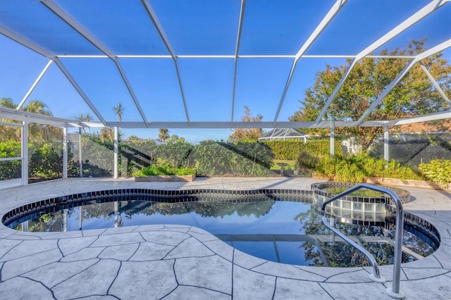 view of swimming pool featuring a patio area and a lanai