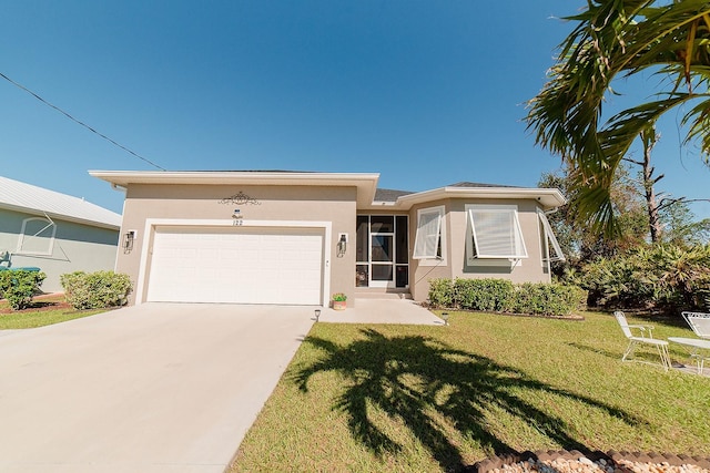 view of front of property with a garage and a front lawn