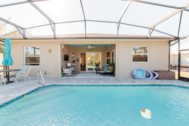 view of swimming pool featuring a patio area, ceiling fan, and a lanai