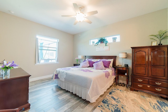 bedroom with ceiling fan and light hardwood / wood-style flooring