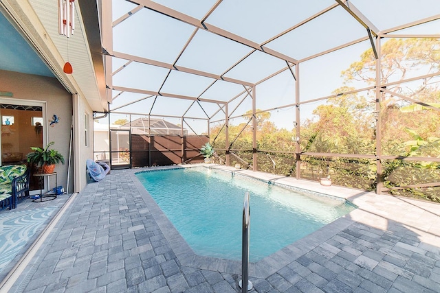 view of swimming pool with a patio and a lanai