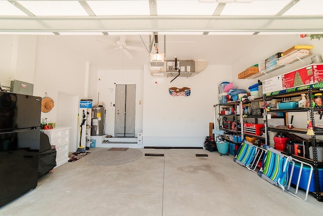 garage featuring a garage door opener, electric water heater, black fridge, and ceiling fan