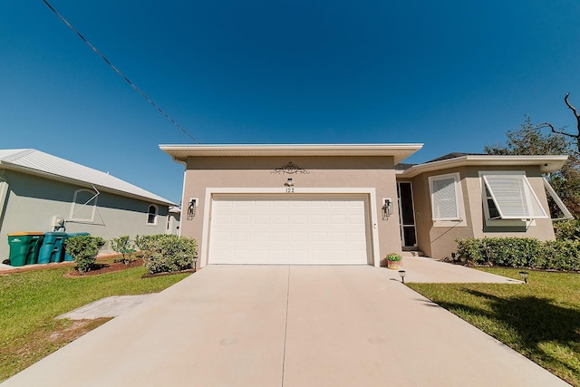 view of front of property with a front yard and a garage