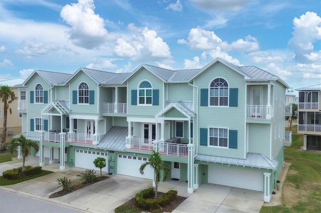10390 Longshore Rd Unit 82, Placida, FL 33946 - view of front of home featuring a garage, driveway, a metal roof, and a standing seam roof