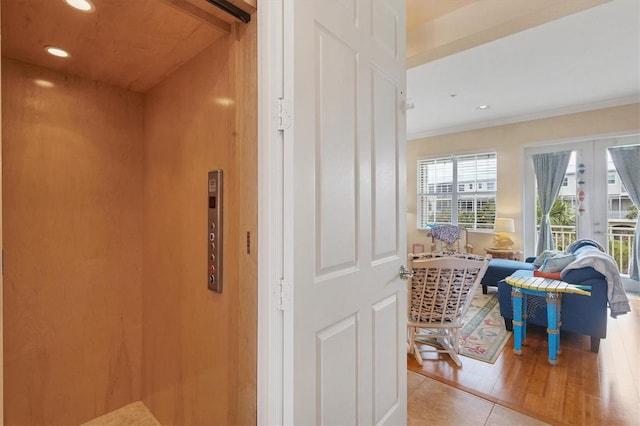 10390 Longshore Rd Unit 82, Placida, FL 33946 - corridor with elevator, french doors, ornamental molding, and recessed lighting