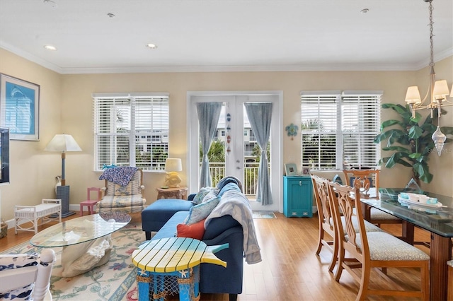 10390 Longshore Rd Unit 82, Placida, FL 33946 - living room featuring plenty of natural light, light wood-style floors, a chandelier, french doors, and ornamental molding