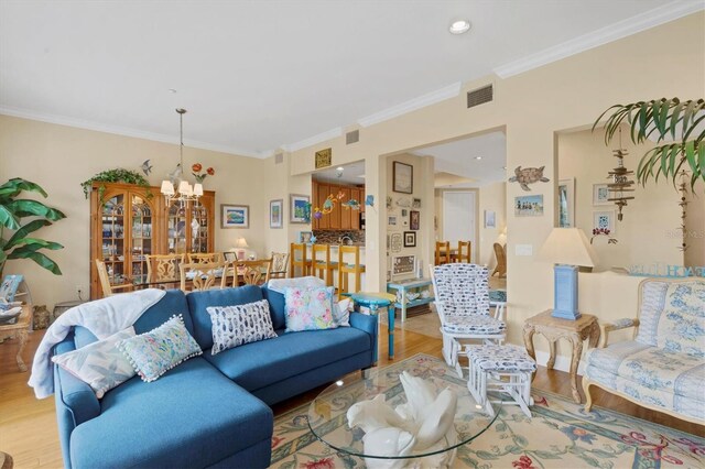 10390 Longshore Rd Unit 82, Placida, FL 33946 - living area with a chandelier, wood finished floors, crown molding, and recessed lighting