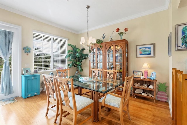 10390 Longshore Rd Unit 82, Placida, FL 33946 - dining room with light wood-style floors, a chandelier, and crown molding