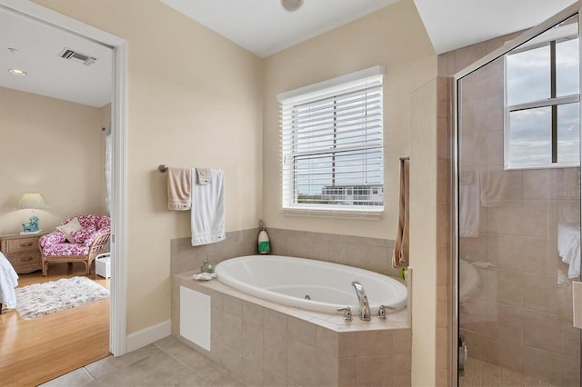 10390 Longshore Rd Unit 82, Placida, FL 33946 - ensuite bathroom with healthy amount of natural light, a tub with jets, and a shower stall