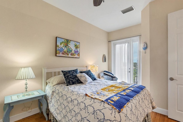 10390 Longshore Rd Unit 82, Placida, FL 33946 - bedroom with wood finished floors and access to exterior
