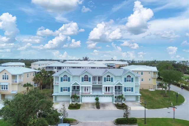 10390 Longshore Rd Unit 82, Placida, FL 33946 - view of front of property featuring a garage, driveway, a balcony, and a metal roof