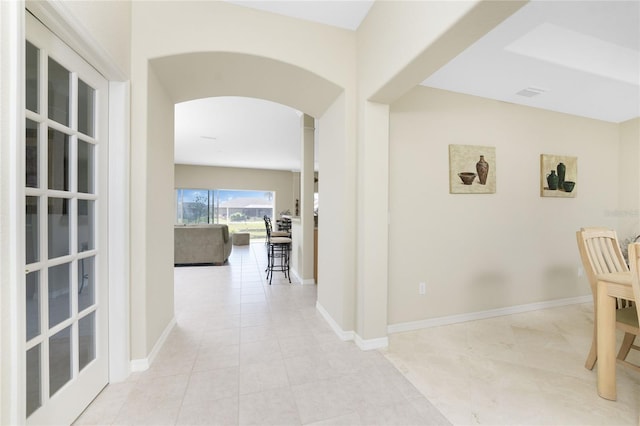 corridor featuring light tile patterned floors