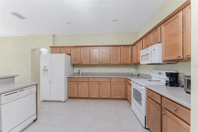 kitchen with light tile patterned floors and white appliances