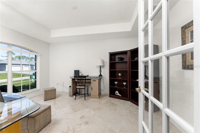 home office featuring a raised ceiling