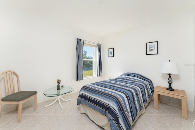 bedroom with light tile patterned floors