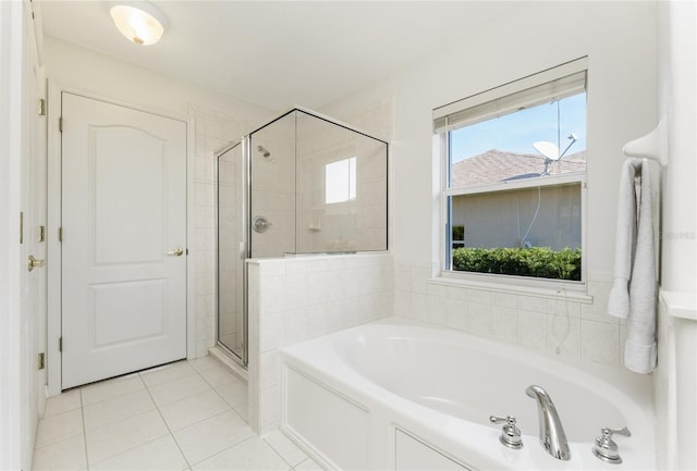 bathroom featuring tile patterned floors and shower with separate bathtub