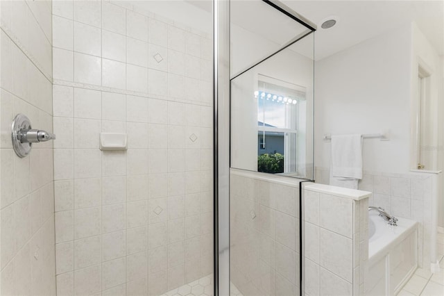 bathroom with tile patterned flooring and independent shower and bath