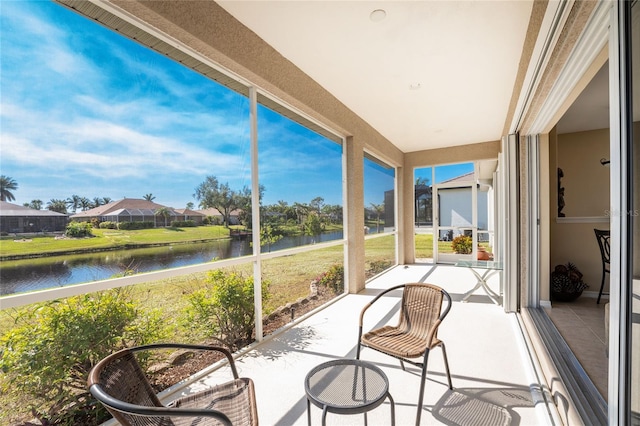 sunroom / solarium with a water view