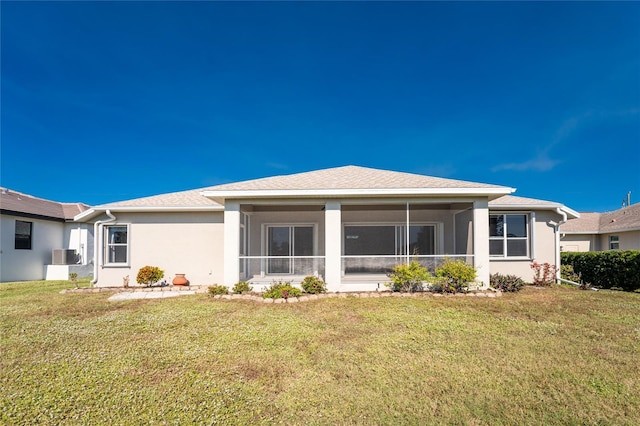 back of property featuring a yard and a sunroom