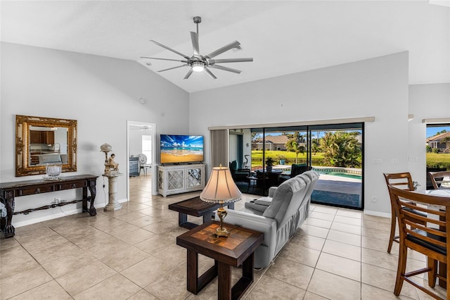 living room featuring ceiling fan, light tile patterned floors, and high vaulted ceiling