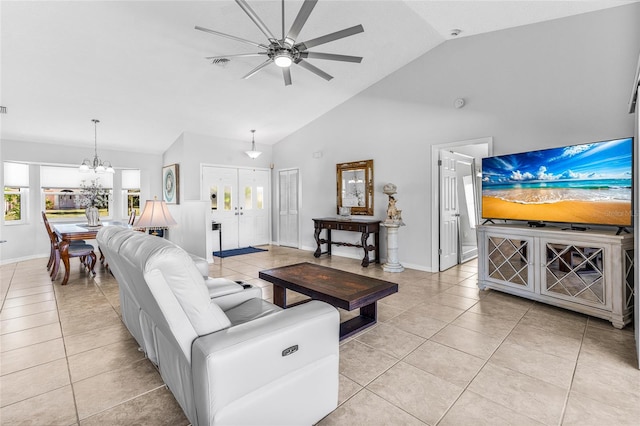 living room featuring ceiling fan with notable chandelier, light tile patterned floors, and high vaulted ceiling