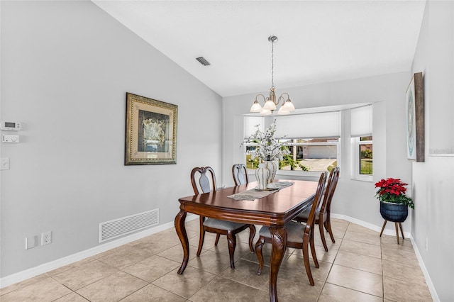 dining area with light tile patterned flooring, vaulted ceiling, and a notable chandelier