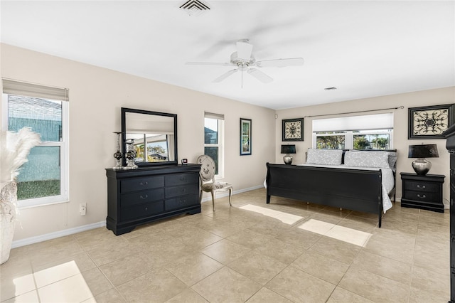 tiled bedroom with multiple windows and ceiling fan