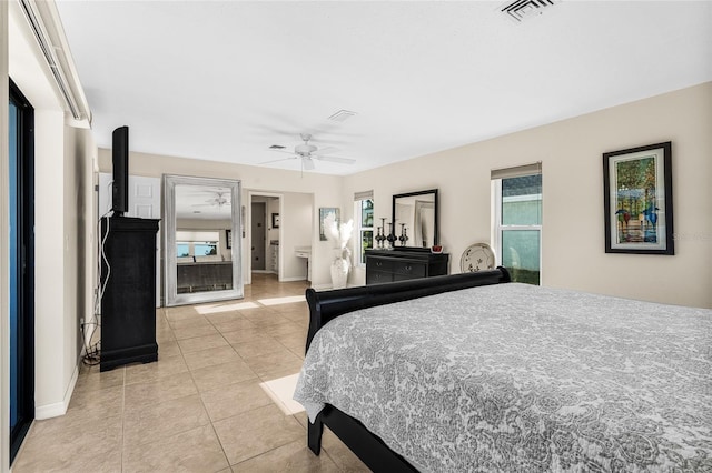 tiled bedroom featuring ceiling fan