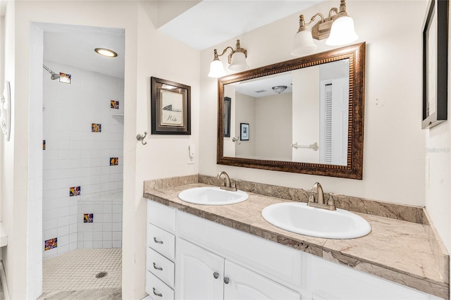 bathroom with vanity and a tile shower