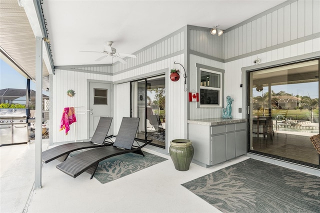 view of patio with area for grilling and ceiling fan