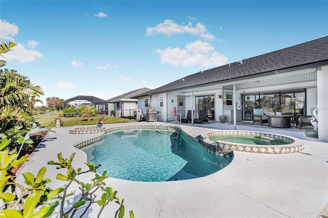 view of swimming pool with a patio area and an in ground hot tub