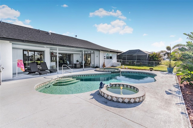 view of pool with an in ground hot tub and a patio