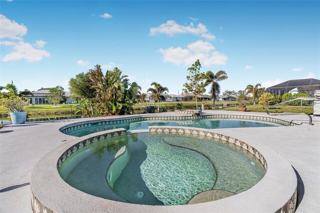 view of pool with an in ground hot tub