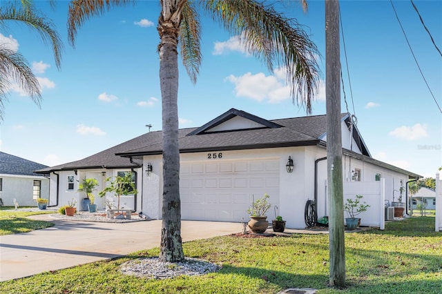 view of front facade featuring a garage and a front lawn