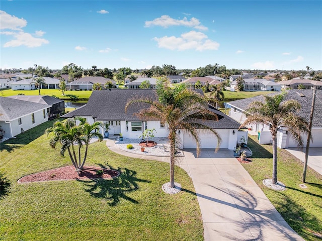 view of front of house with a front yard and a garage