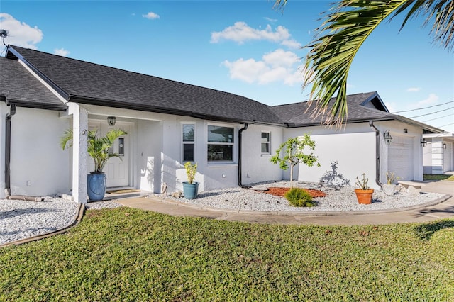 ranch-style house featuring a front lawn and a garage