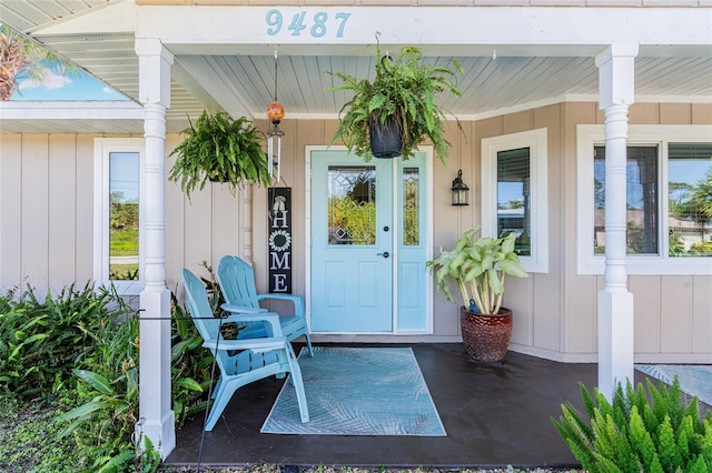 view of exterior entry featuring covered porch