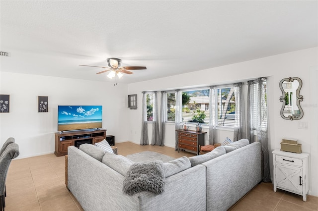 living room with ceiling fan and light tile patterned floors