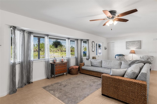 living room with ceiling fan and light tile patterned flooring