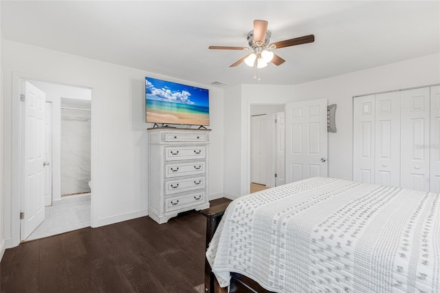 bedroom featuring ceiling fan, dark hardwood / wood-style flooring, and connected bathroom