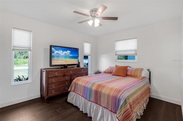 bedroom with ceiling fan and dark wood-type flooring