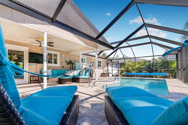 view of swimming pool with an outdoor living space, ceiling fan, a patio, and glass enclosure